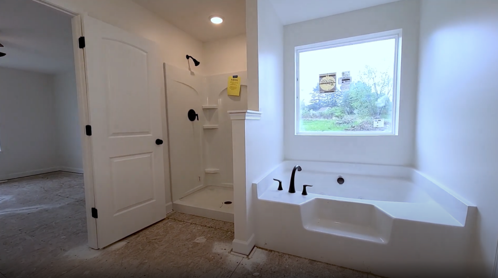 Owner suite's luxury bath: separate tub and walk-in shower